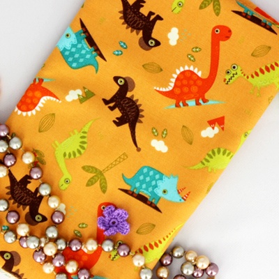 Ткань Оксфорд, Динозаврики на оранжевом фоне, 45х55 см